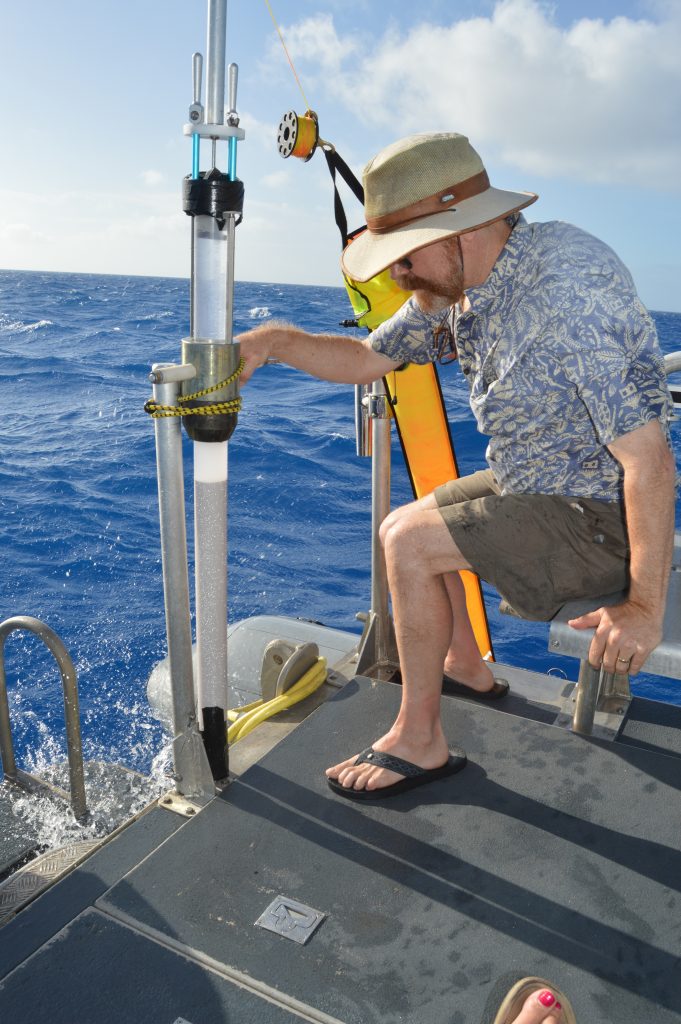 Ken Buesseler securing the recovered core onto the dive boat. 