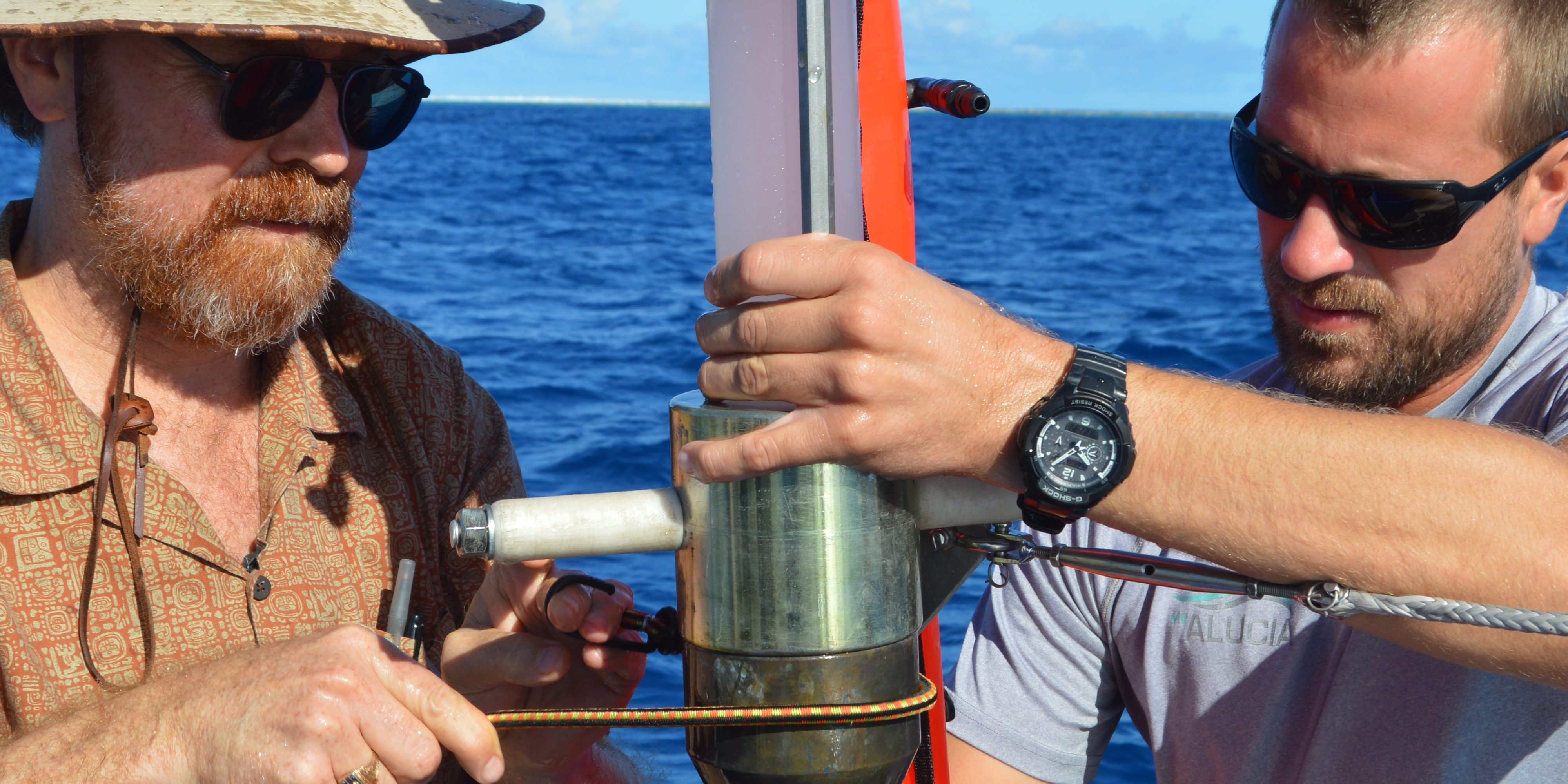 Ken Buesseler and a crew member assembling the sediment coring device. 